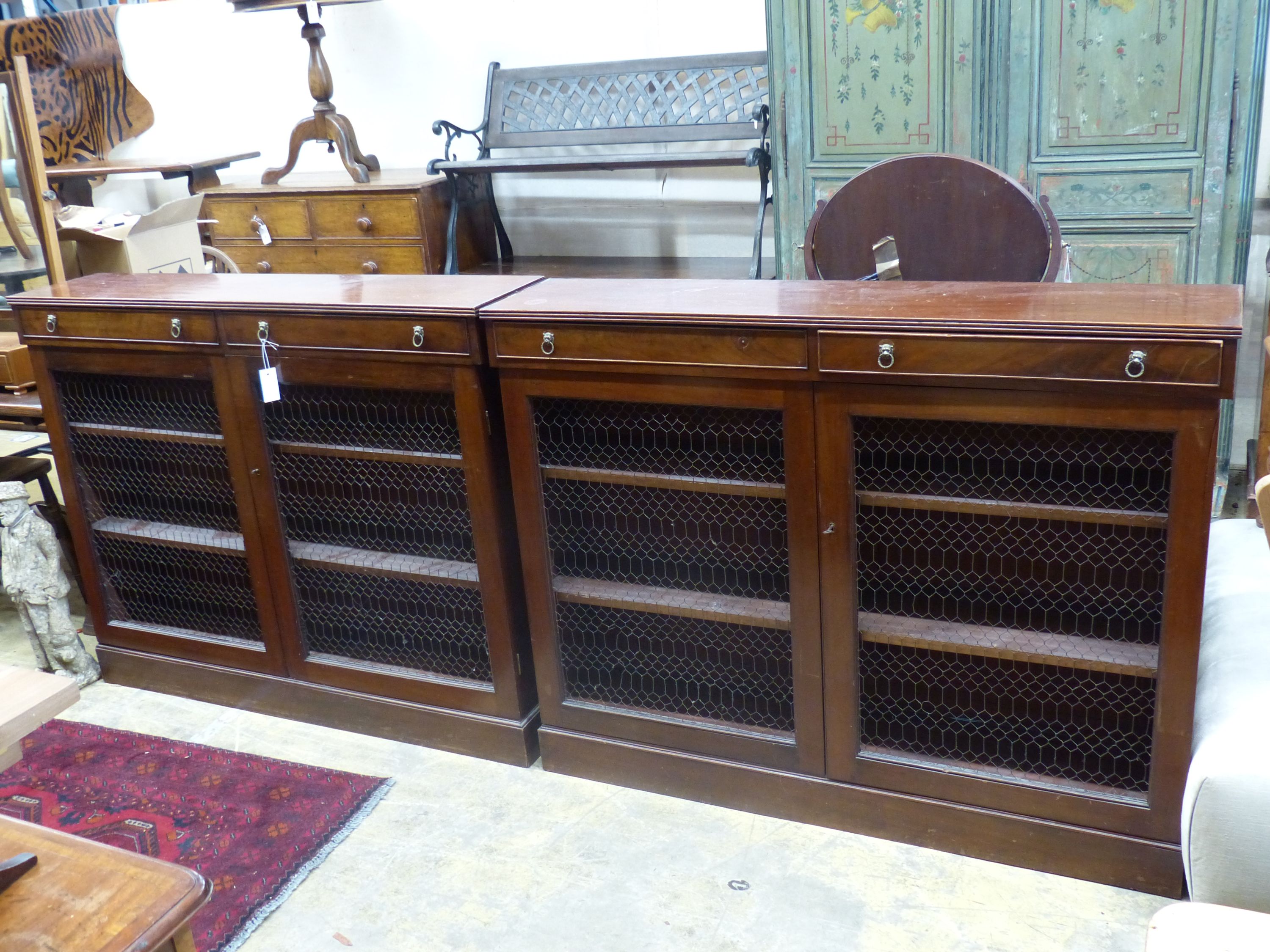 A pair of Regency style mahogany side cabinets, width 131cm, depth 28cm, height 104cm